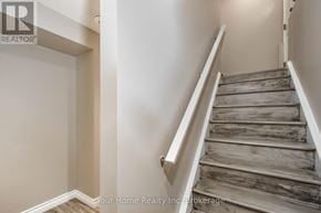 Guelph (Kortright East) apartment for rent - A staircase with wooden steps and white railings.