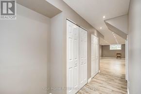 Guelph (Kortright East) apartment for rent - A realtor brochure showing a white interior room with a door and a window.