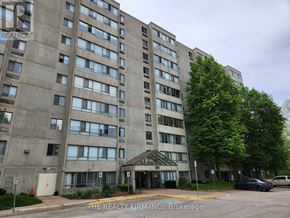 London North (North N) condo for rent - A large concrete building with a parking lot in front.
