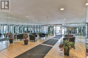 London North (North N) condo for rent - A reception area with a glass wall and a sign that says "The Realty Firm N.C., Brokerage.".