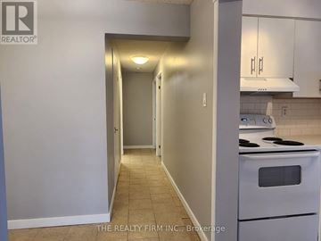 London North (North N) condo for rent - A kitchen with a stove and a doorway leading to another room.