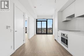 Toronto (Thorncliffe Park) condo for rent - A spacious kitchen with white cabinets and a large window.