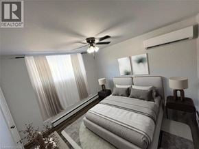 Kitchener apartment for rent - A bedroom with a large bed and a ceiling fan.