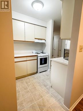Orangeville multi-family for rent - A kitchen with a stove top oven and a microwave.