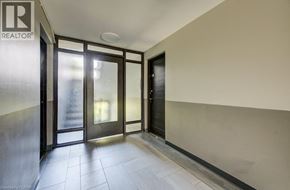 London apartment for rent - A hallway with a glass door and a black door.