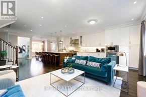 Toronto (Leaside) townhouse for rent - A modern living room with a blue couch and a coffee table.