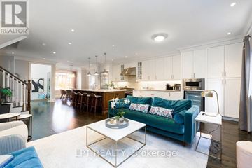 Toronto (Leaside) townhouse for rent - A modern living room with a blue couch and a coffee table.