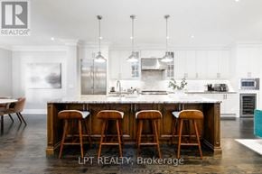 Toronto (Leaside) townhouse for rent - A modern kitchen with a large island and bar stools.