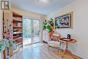 Vaughan (Maple) townhouse for rent - A living room with a chair, a table, and a painting on the wall.