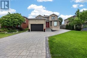 Barrie (Holly) apartment for rent - A house with a brick driveway and a garage door is for sale.