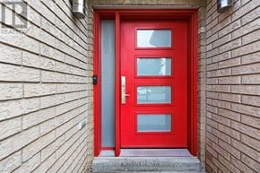 Barrie (Holly) apartment for rent - A red door with a glass window is set in a brick wall.
