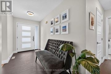 Barrie (Holly) apartment for rent - A living room with a black couch and a wall with pictures.