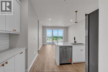 Blenheim apartment for rent - A kitchen with white cabinets and a wooden floor.