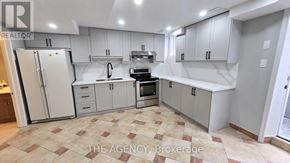 Vaughan (Patterson) apartment for rent - A kitchen with white cabinets and a tiled floor.