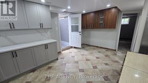 Vaughan (Patterson) apartment for rent - A kitchen with white cabinets and a tiled floor.