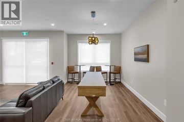 Tilbury apartment for rent - A living room with a grey couch, a wooden table, and a painting on the wall.