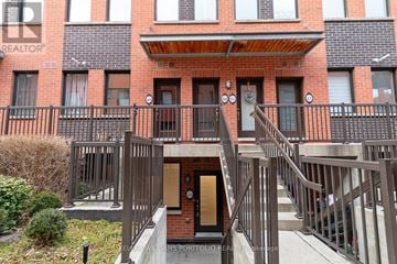 Toronto (Downsview-Roding-Cfb) townhouse for rent - A building with a balcony and a door in the center.