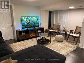Toronto (Woburn) apartment for rent - A living room with a television, a fireplace, and a couch.