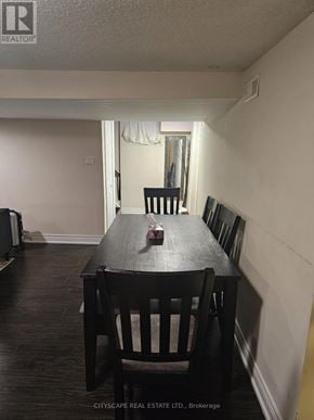 Toronto (Woburn) apartment for rent - A dining room with a wooden table and chairs.