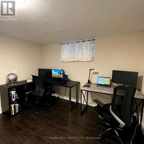 Toronto (Woburn) apartment for rent - A room with two desks and chairs, one of which is a standing desk.