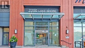 Toronto (Mimico) condo for rent - The front of a building with a sign that says 2200 Lake Shore.