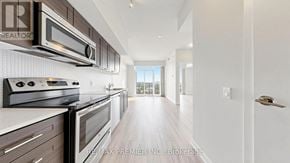 Toronto (Mimico) condo for rent - A modern kitchen with stainless steel appliances and wooden floors.