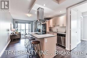 Toronto (Mimico) condo for rent - A modern kitchen with a bar stool and a large island.