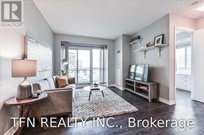 Toronto (Mimico) condo for rent - A well-lit living room with a couch, a coffee table, and a television set.