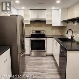 Hamilton apartment for rent - A modern kitchen with a stainless steel refrigerator and white cabinets.