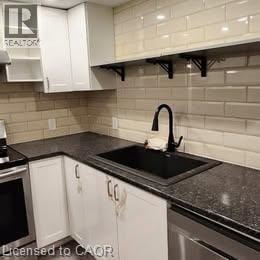 Hamilton apartment for rent - A kitchen with black countertops and white cabinets.
