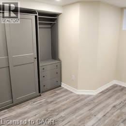 Hamilton apartment for rent - A bedroom with a built-in closet and drawers.