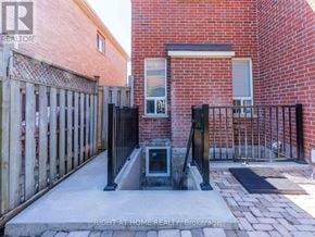 Vaughan (Maple) apartment for rent - A brick house with a gate and a small window.