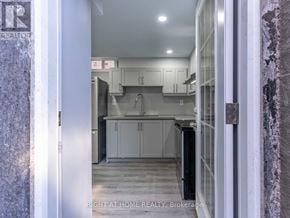Vaughan (Maple) apartment for rent - A kitchen with white cabinets and a black refrigerator.