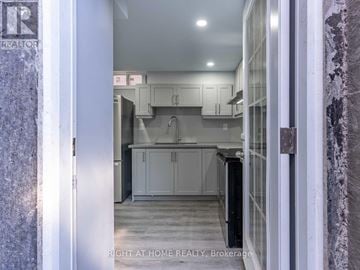 Vaughan (Maple) apartment for rent - A kitchen with white cabinets and a black refrigerator.