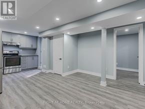 Vaughan (Maple) apartment for rent - A spacious kitchen with a stainless steel oven and a grey floor.