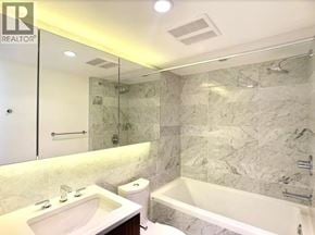 Vancouver apartment for rent - A bathroom with a marble wall and a bathtub.