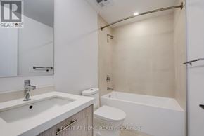 Toronto (Junction Area) condo for rent - A white bathroom with a sink, toilet, and bathtub.
