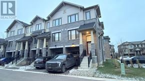 Hamilton (Stoney Creek Mountain) townhouse for rent - A large, modern house with a car parked in front.