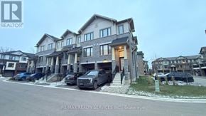 Hamilton (Stoney Creek Mountain) townhouse for rent - A building with the RE/MAX Realty Services Inc. logo on it.