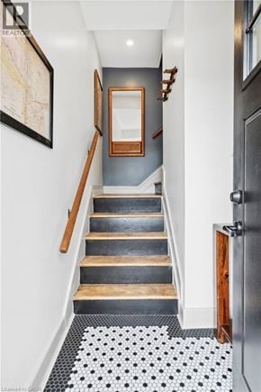 Hamilton apartment for rent - A hallway with a staircase and a framed map on the wall.