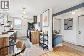 Hamilton apartment for rent - A kitchen with a black refrigerator and a wooden island.