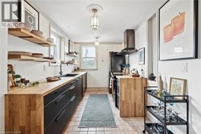 Hamilton apartment for rent - A modern kitchen with wooden cabinets and a black stove top.