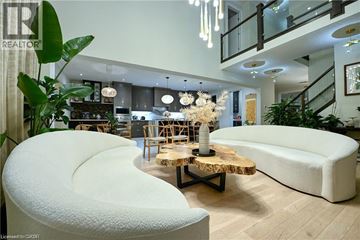 Kitchener apartment for rent - A modern living room with a white sofa and a wooden coffee table.