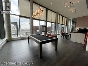 Kitchener condo for rent - A modern living room with a black sofa and a white coffee table.