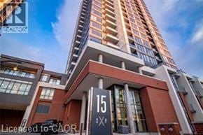 Kitchener condo for rent - A modern kitchen with stainless steel appliances and wooden flooring.