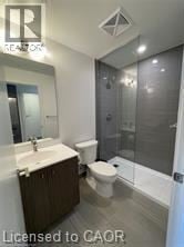 Kitchener condo for rent - A bathroom with a toilet, sink, and shower.