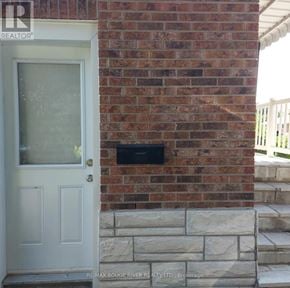 Oshawa (Mclaughlin) multi-family for rent - A white door is on the left of a brick wall.