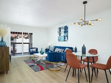 San Antonio apartment for rent - A living room with a blue couch and a glass table.