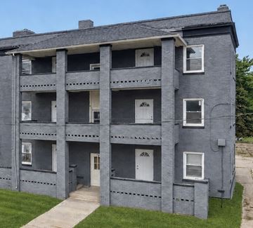 Ashtabula apartment for rent - A grey building with white doors and windows.