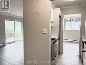 St. Catharines (Carlton/Bunting) condo for rent - A modern kitchen with a black countertop and white walls.